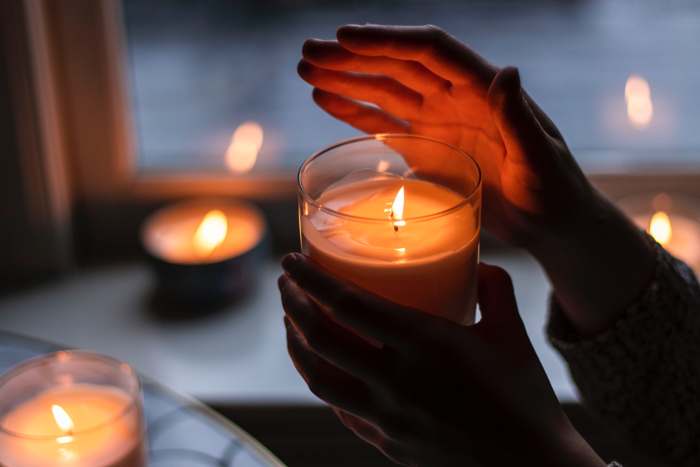 Lit candle used during a Moon Circle ritual with Blandine in Lisbon